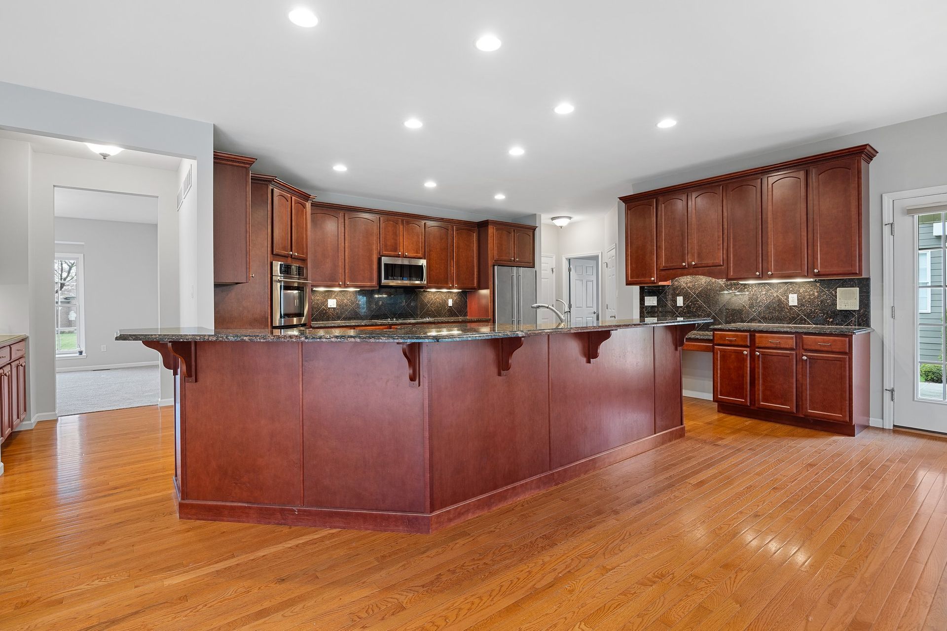 A kitchen with a large island and wooden cabinets