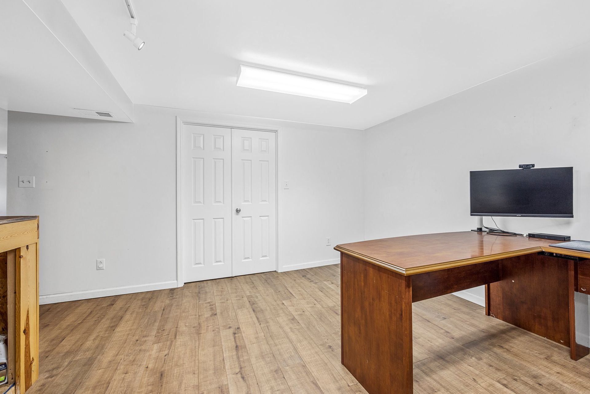 There is a desk and a television in the room.