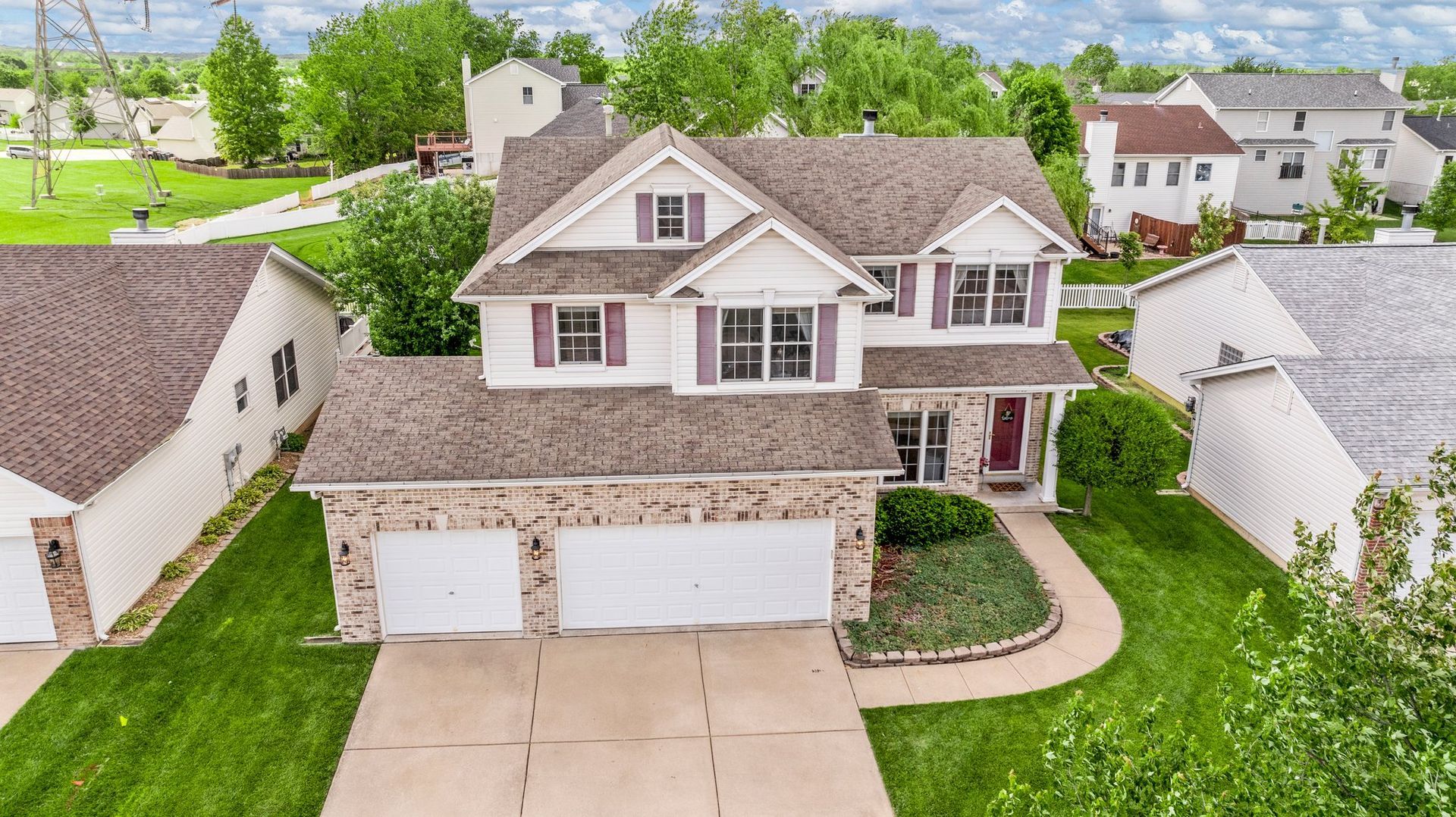 An aerial view of a large house in a residential area.