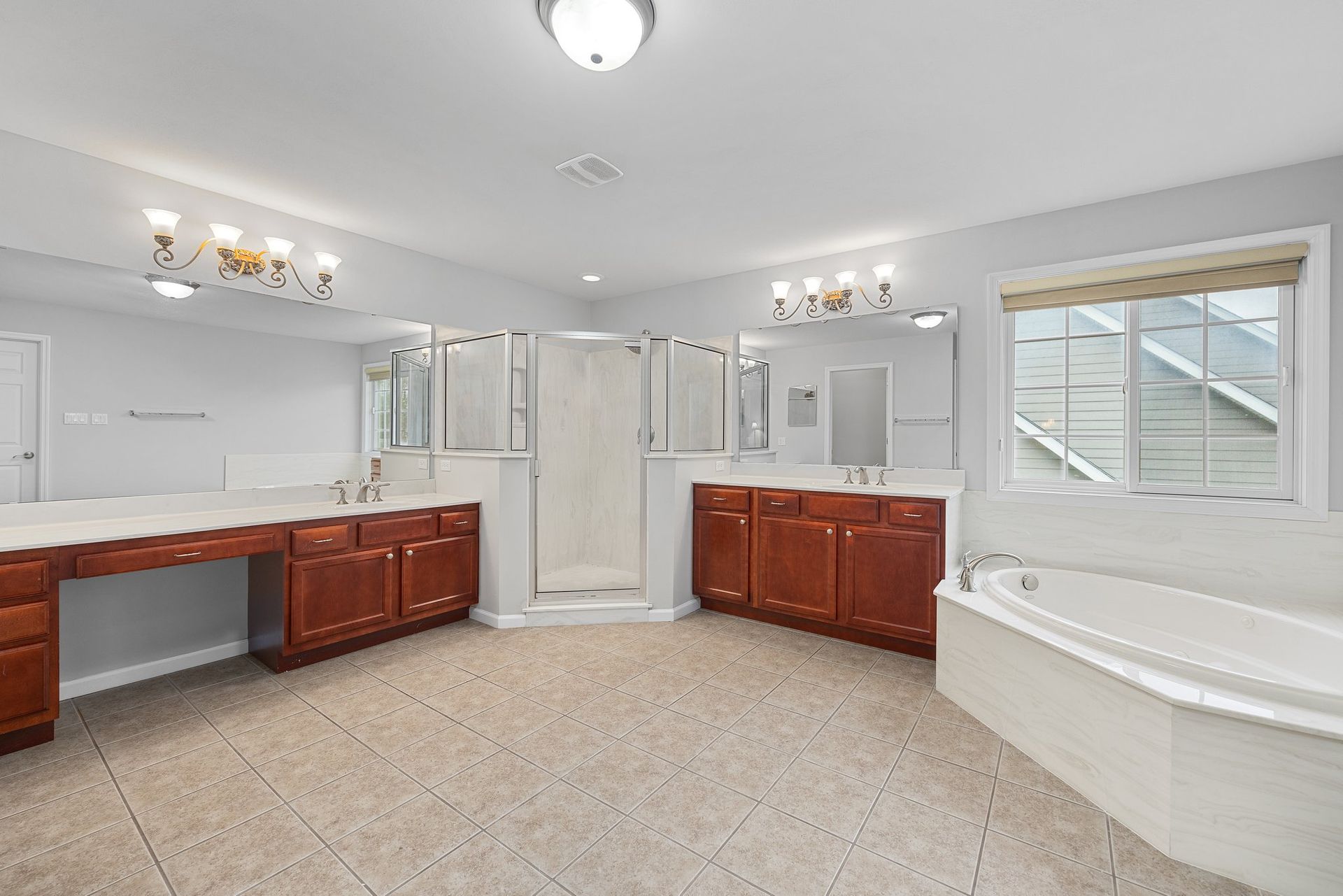 A bathroom with two sinks , a tub , and a shower.