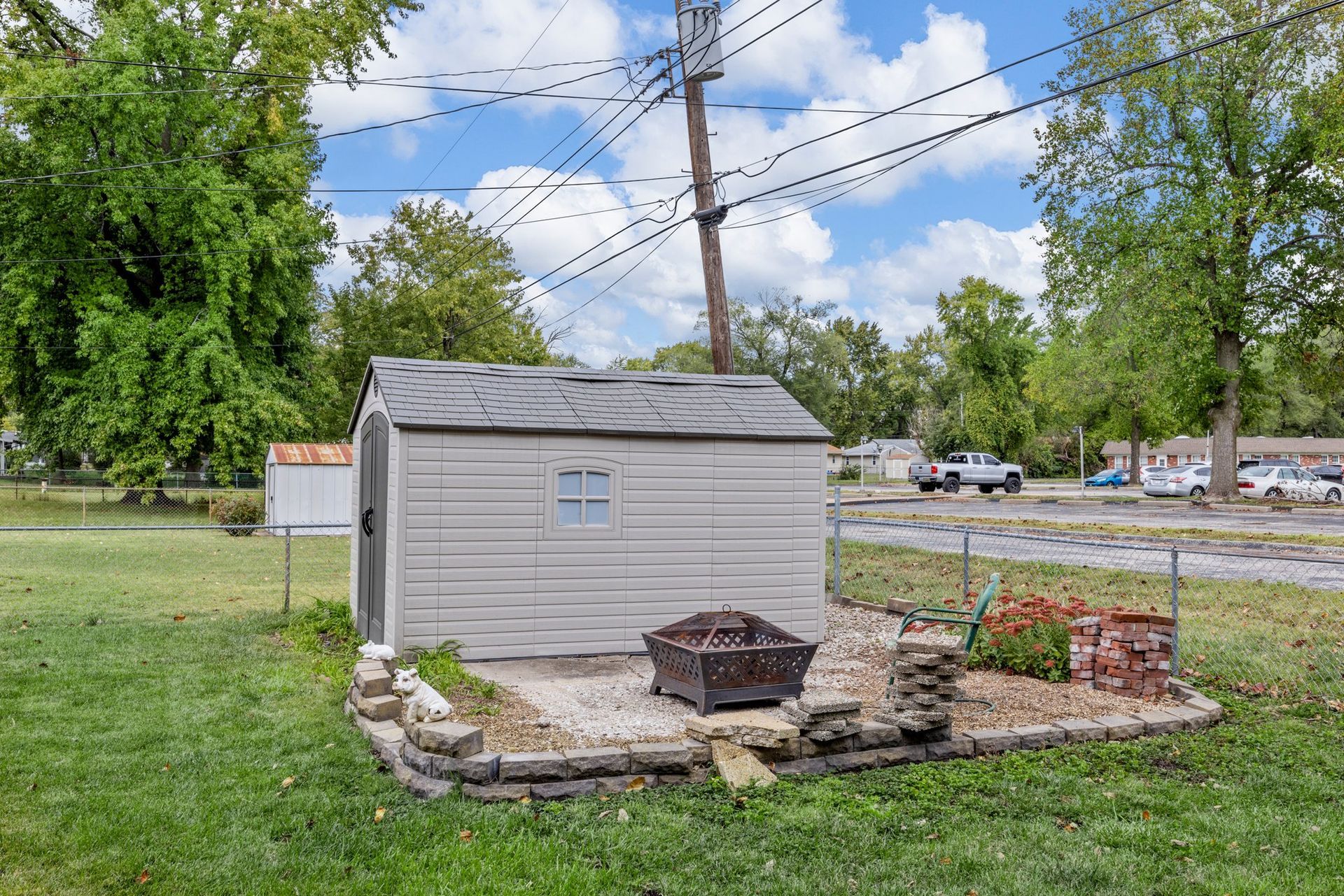 A small shed with a fire pit in the backyard.