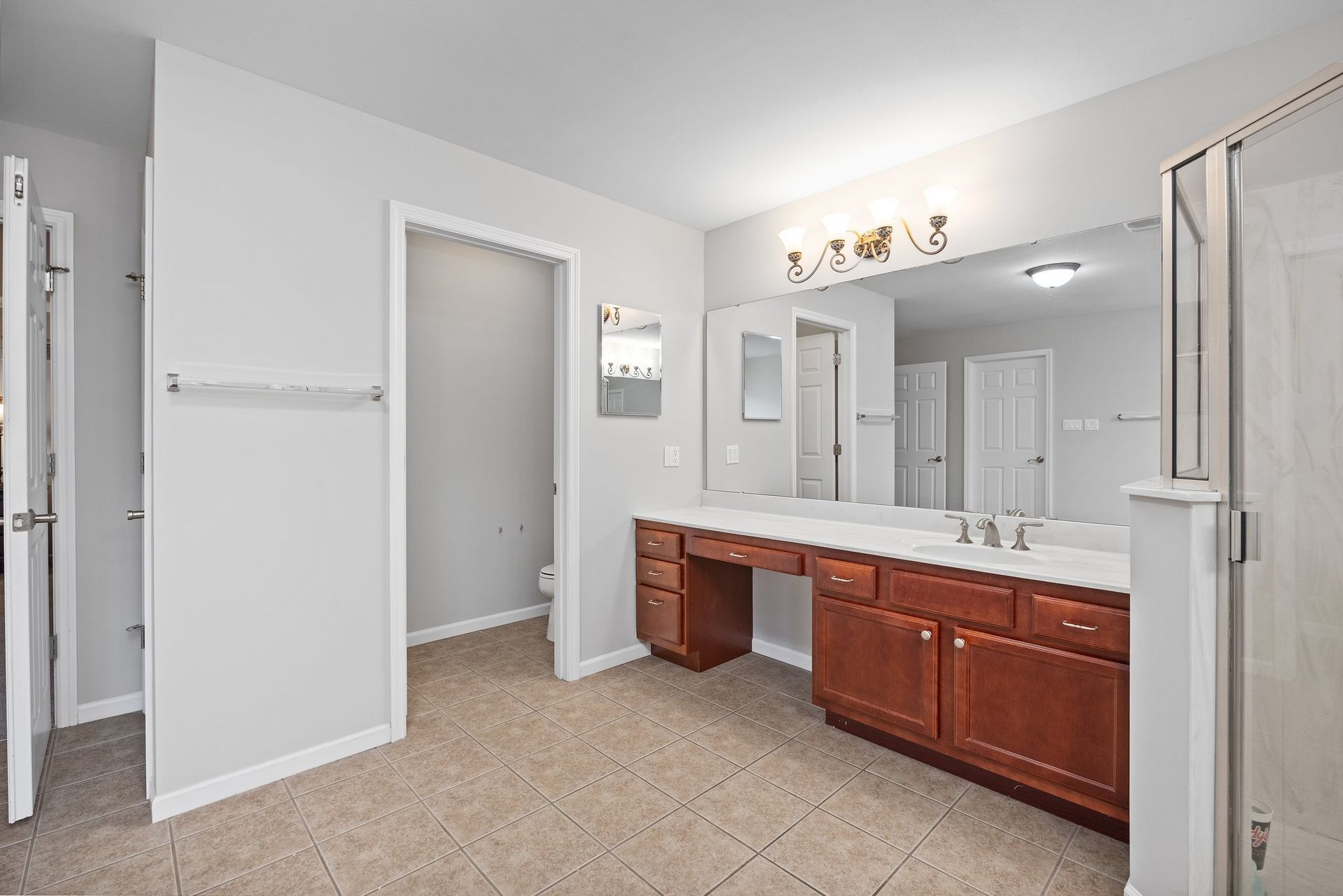A bathroom with two sinks and a large mirror.