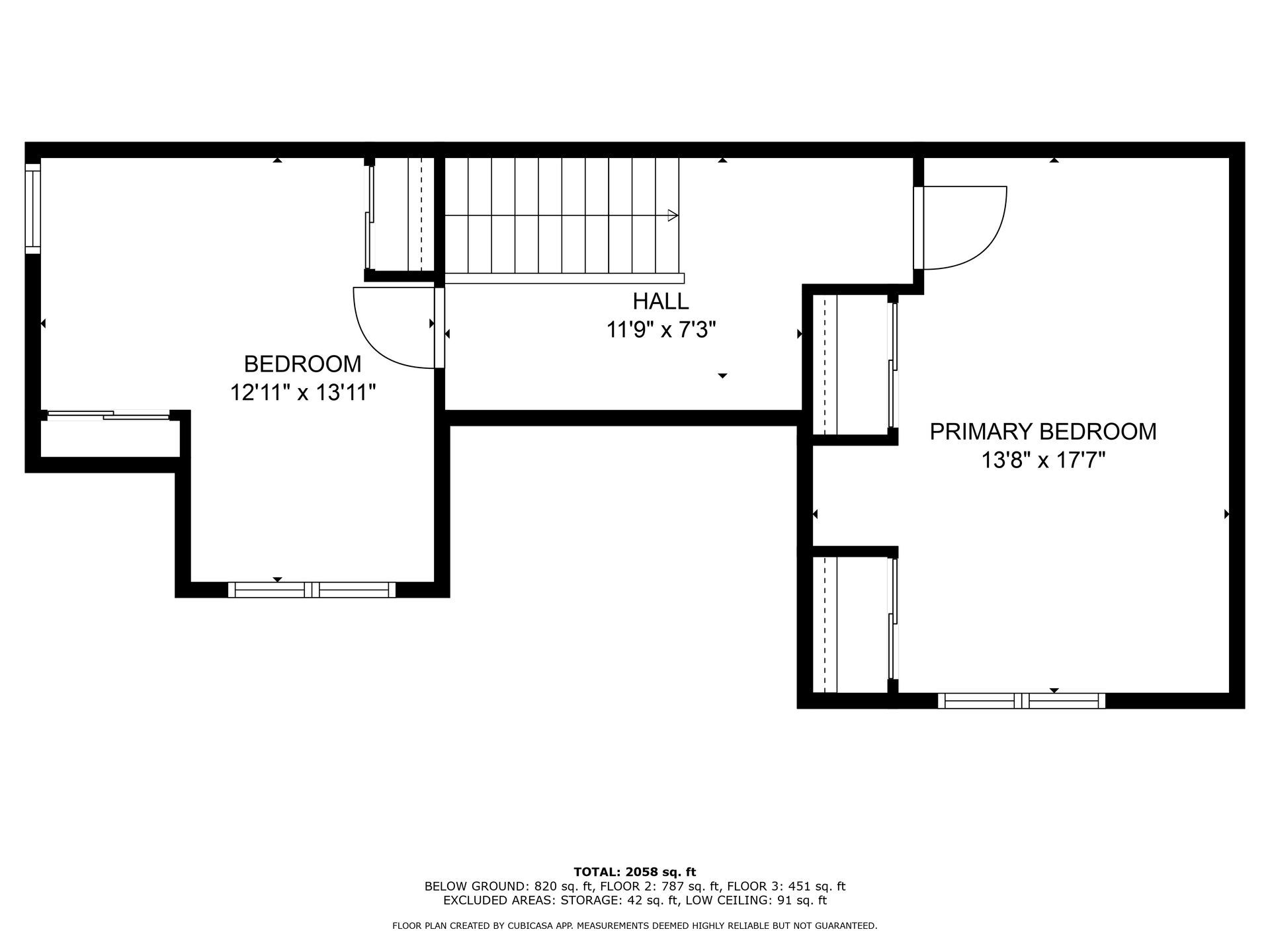 A black and white floor plan of a house with a staircase.