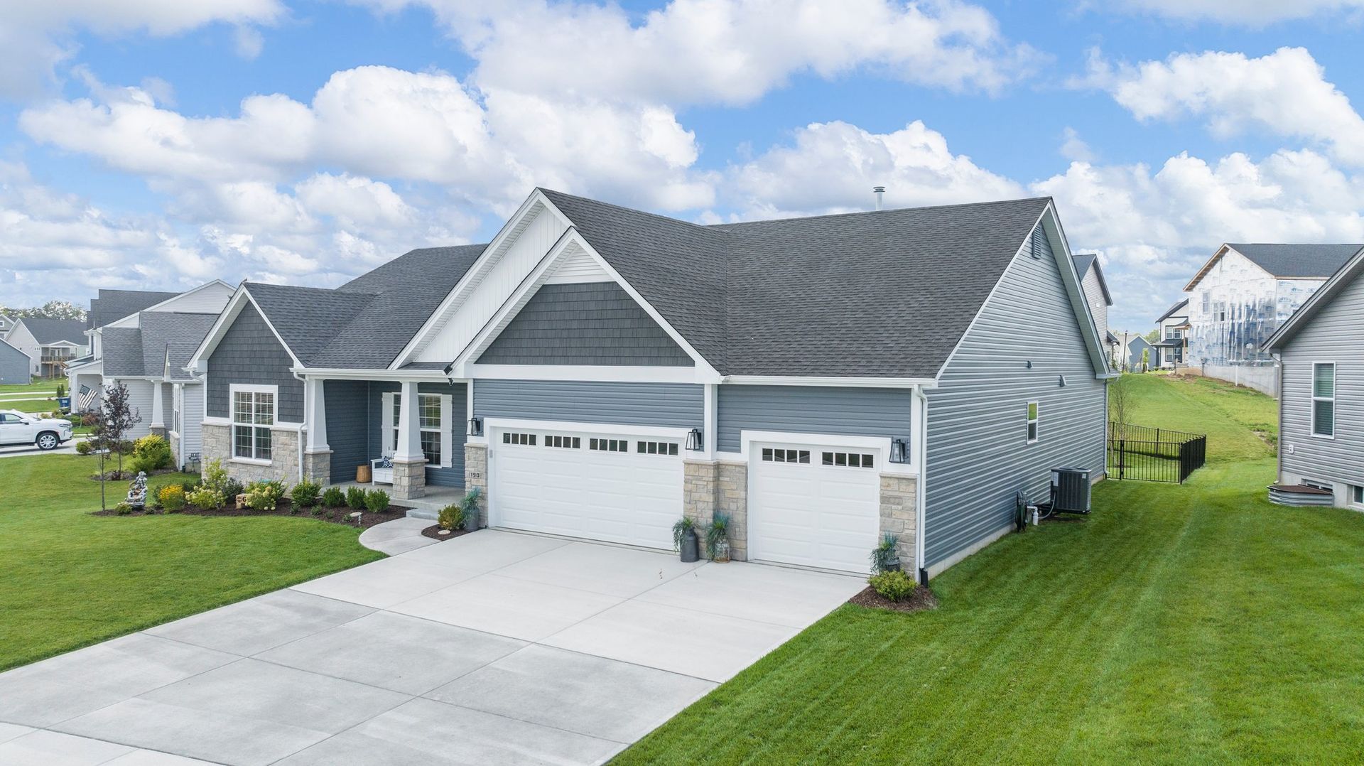 A house with a driveway and a garage in a residential area.