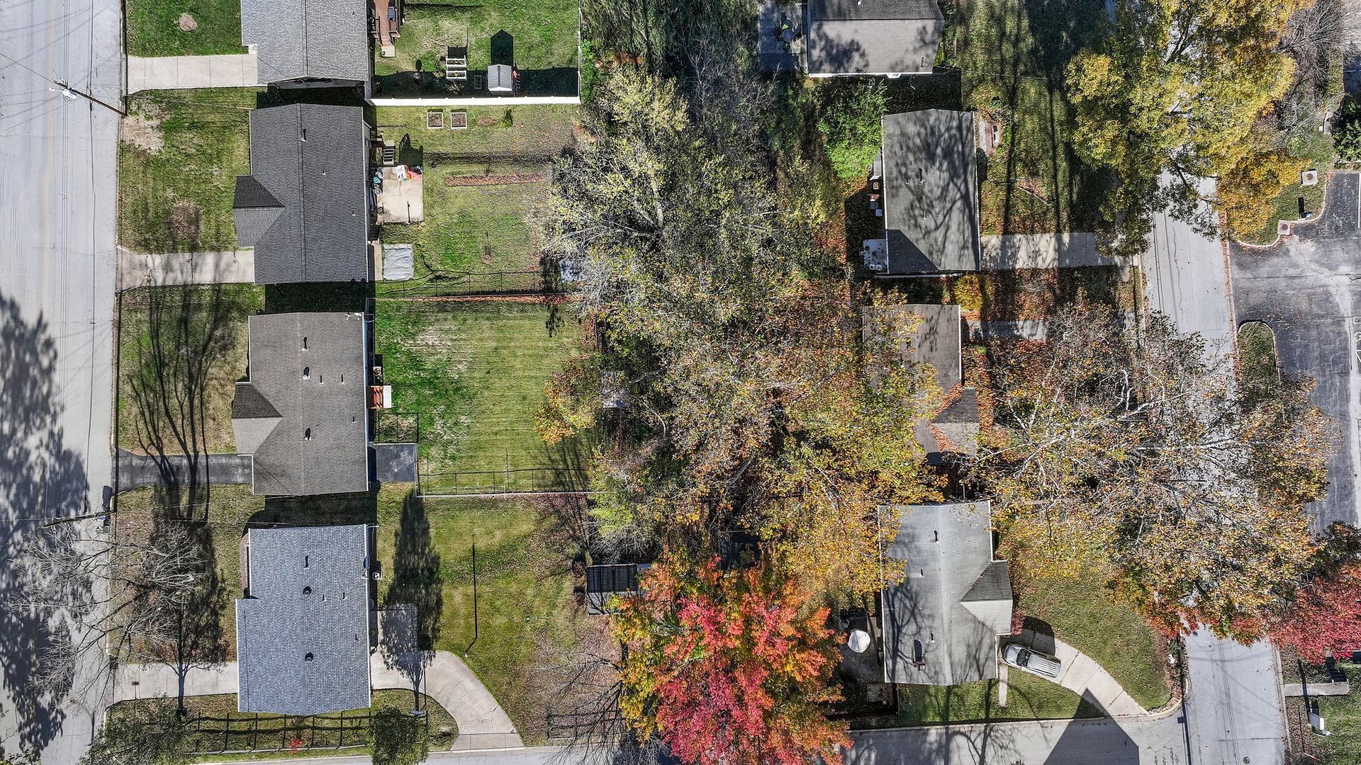 An aerial view of a residential neighborhood with houses and trees.