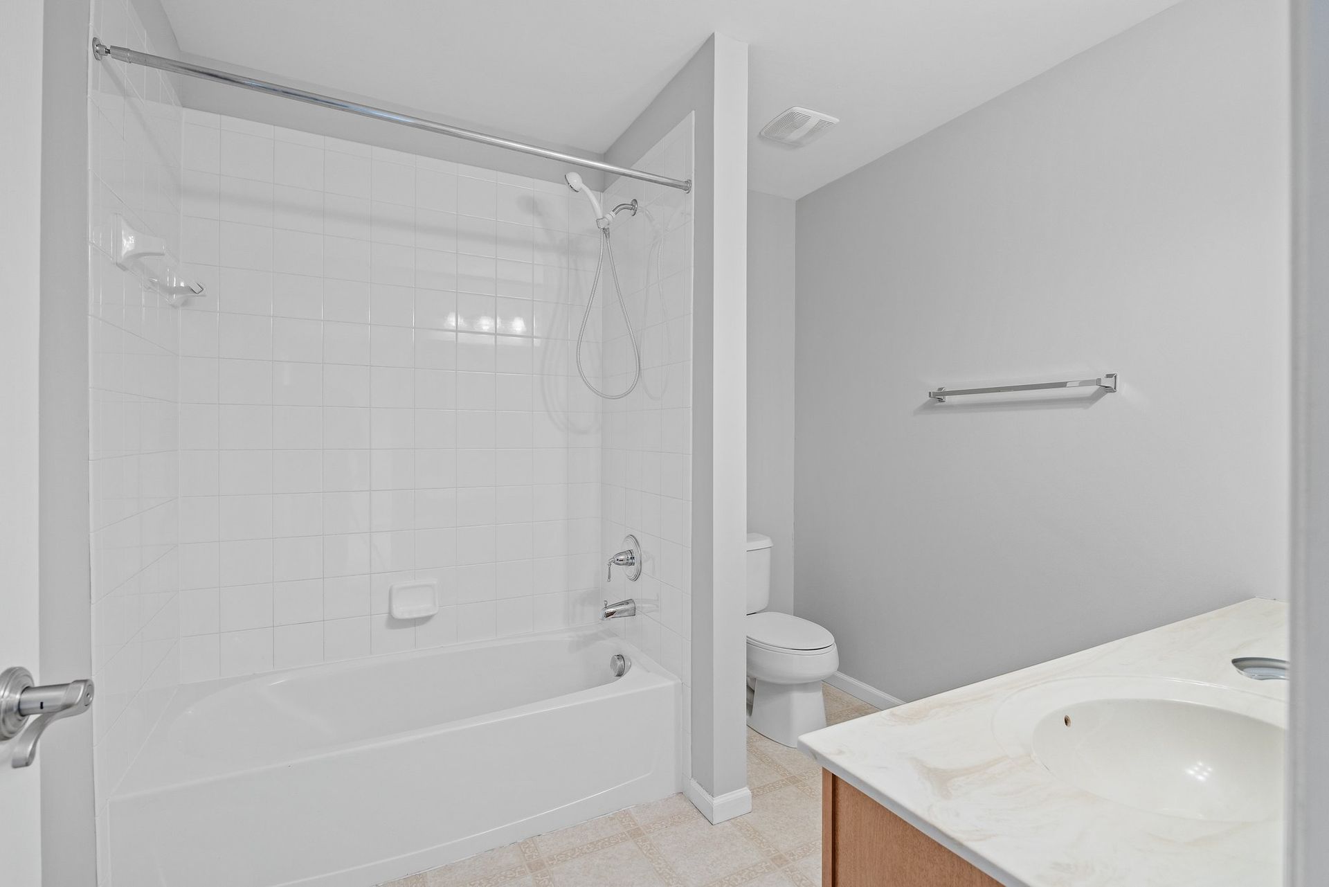 A bathroom with a tub , toilet , sink and shower.