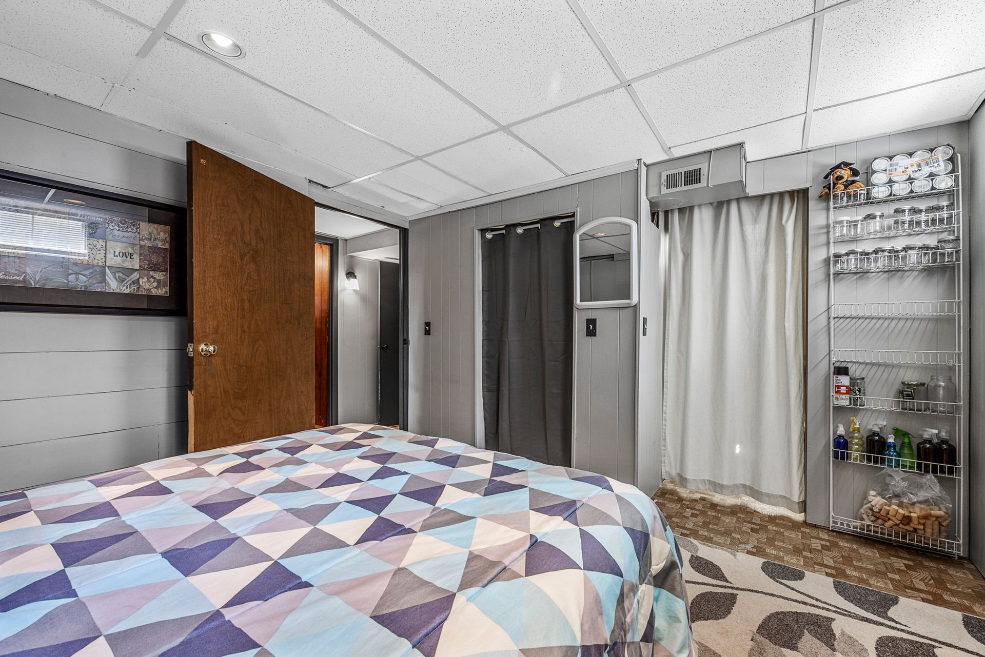 A bedroom with a large bed and a closet.