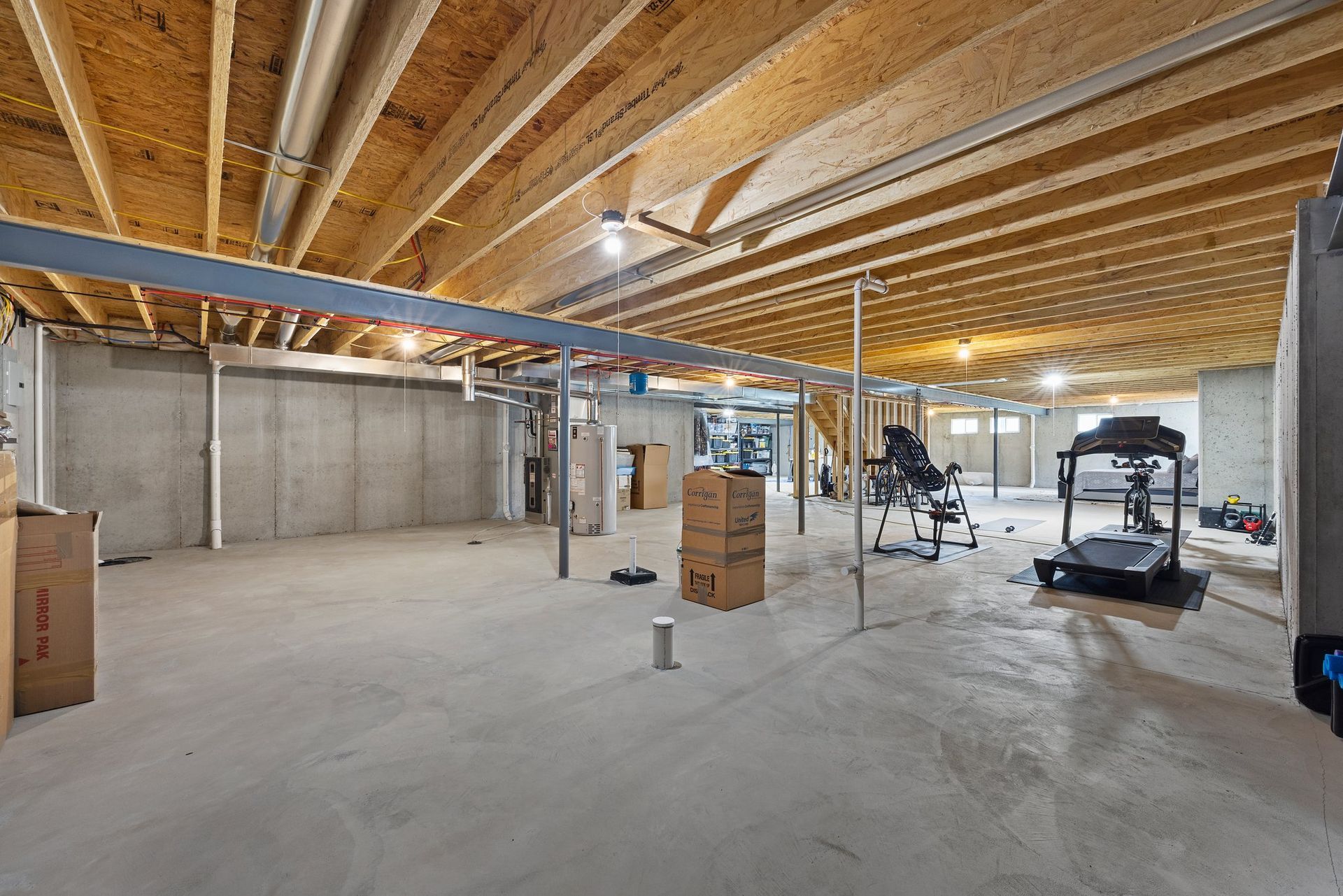 There is a treadmill in the basement of a house.