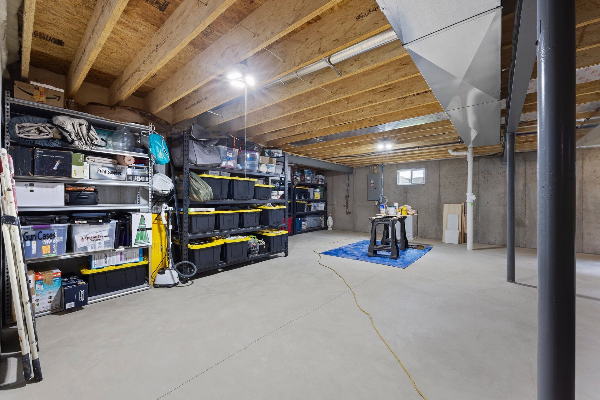 A basement filled with lots of shelves and bins.