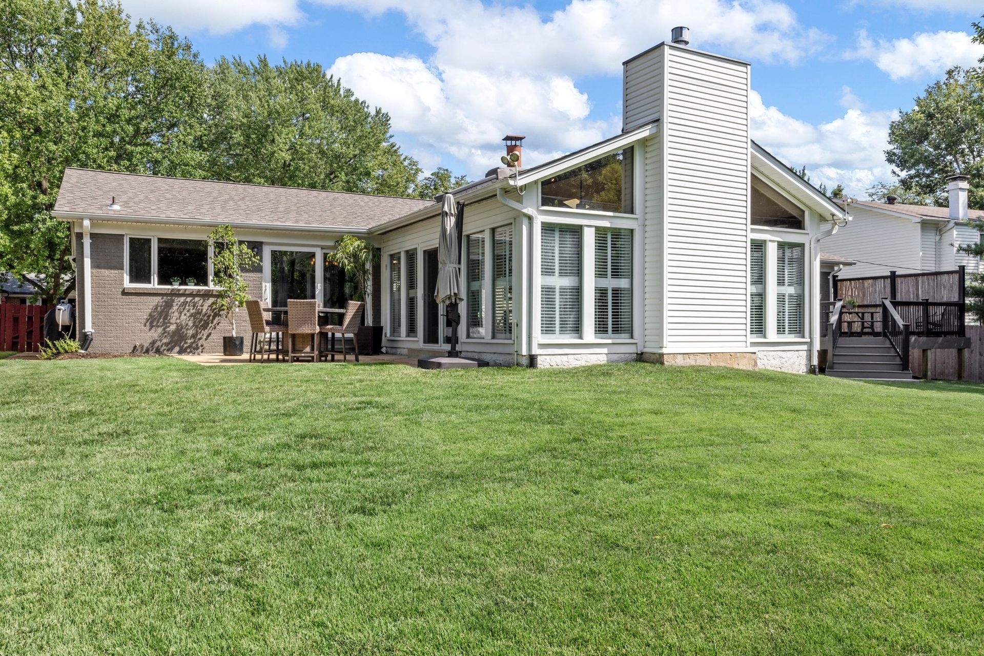 A large house with a large lawn in front of it.