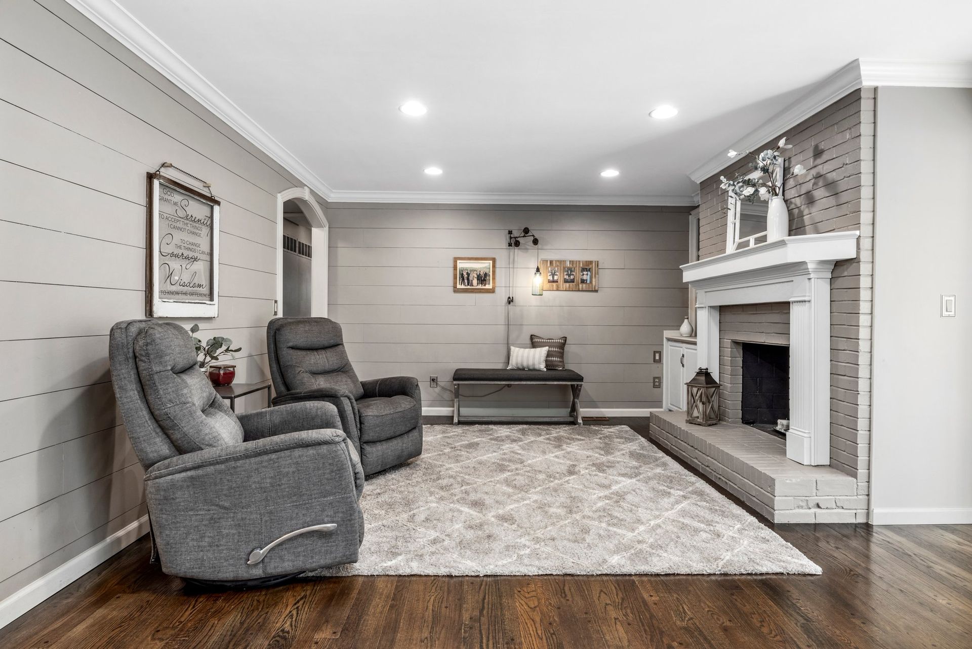 A living room with two recliner chairs and a fireplace.