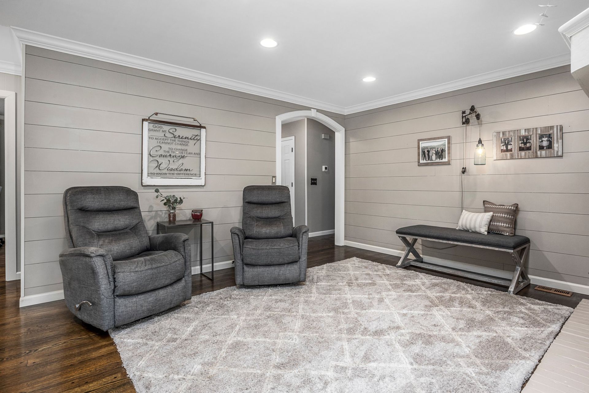 A living room with two recliner chairs and a bench.