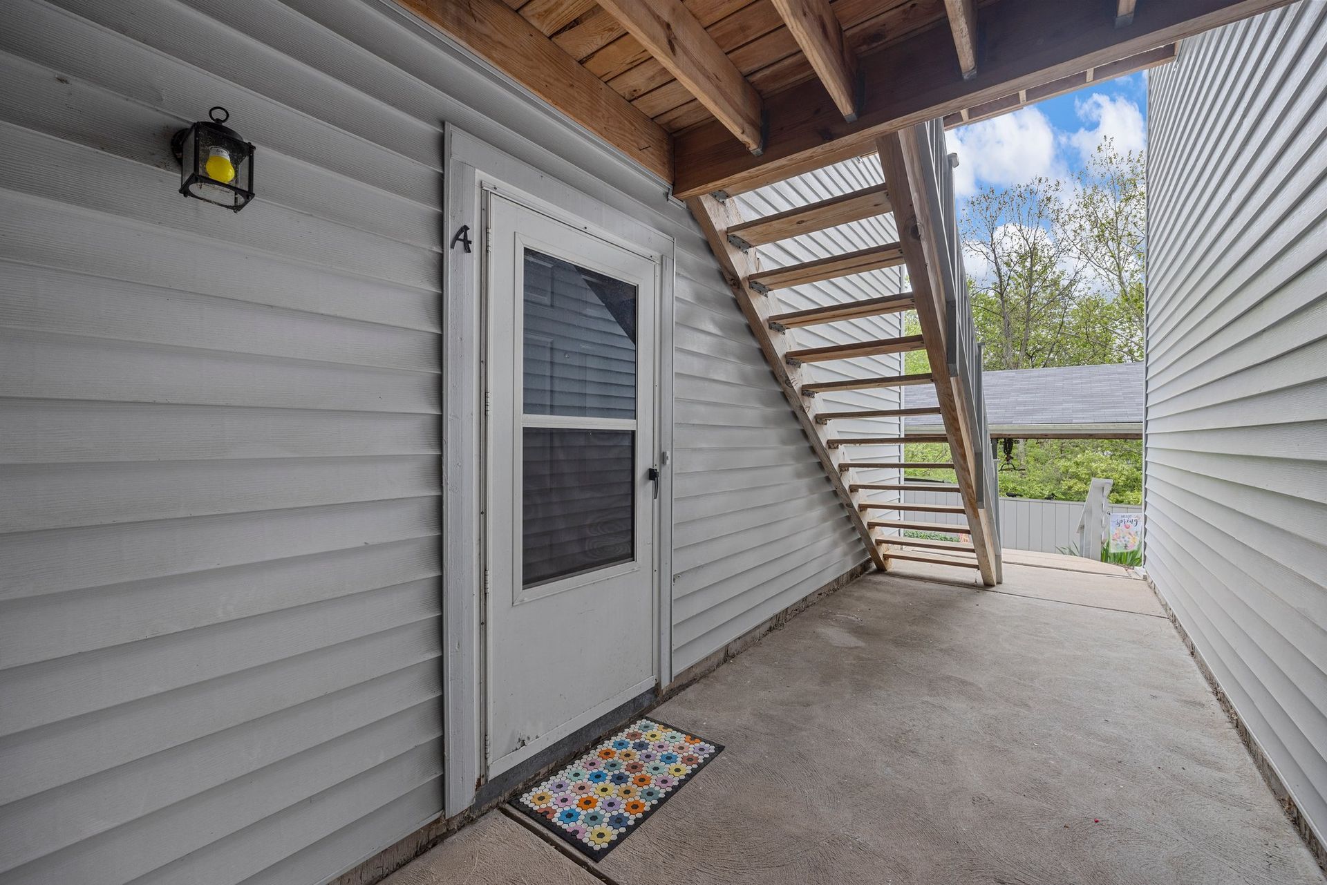 A doorway with stairs leading up to the second floor of a house.