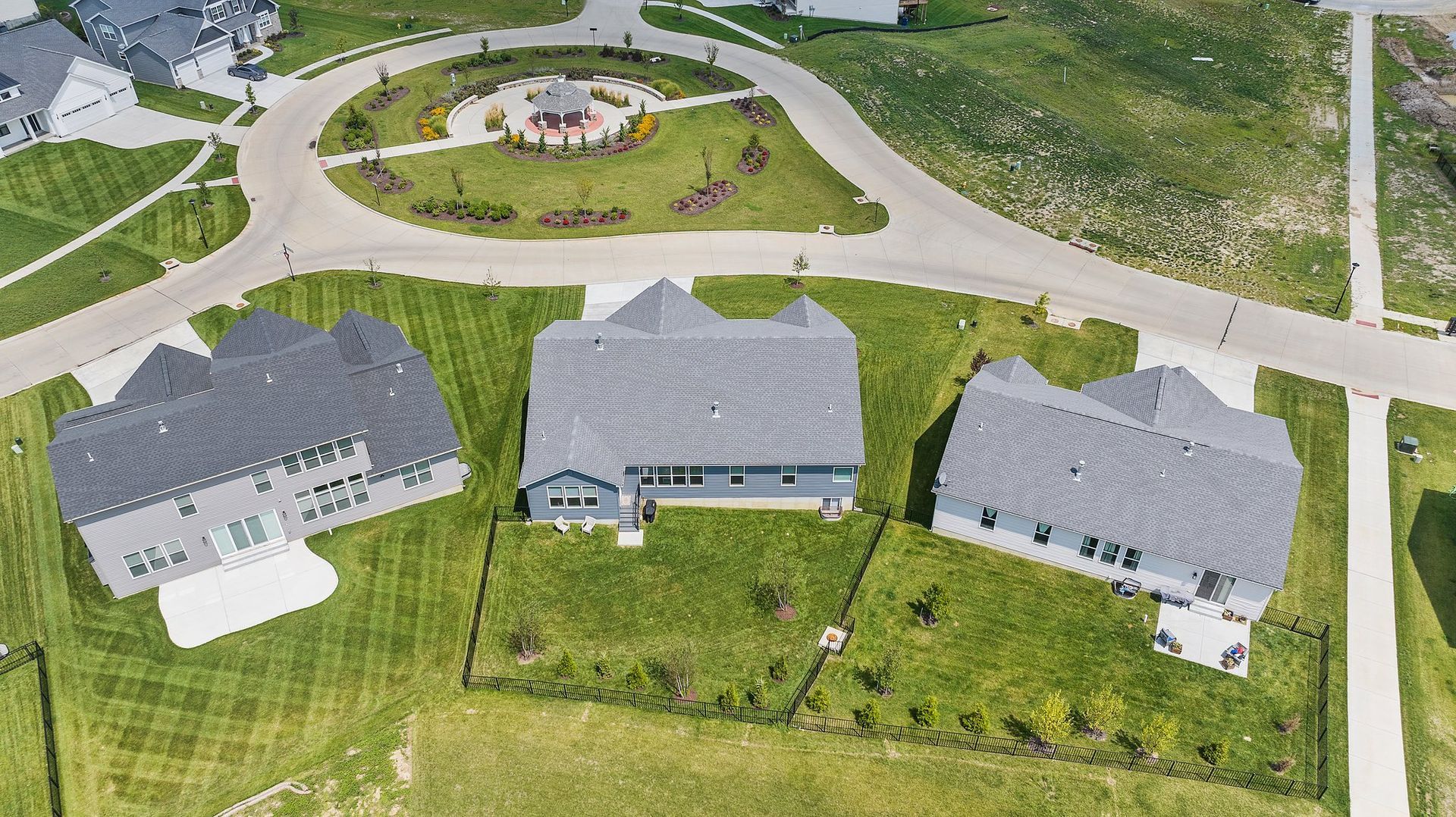 An aerial view of a residential area with houses and a road.