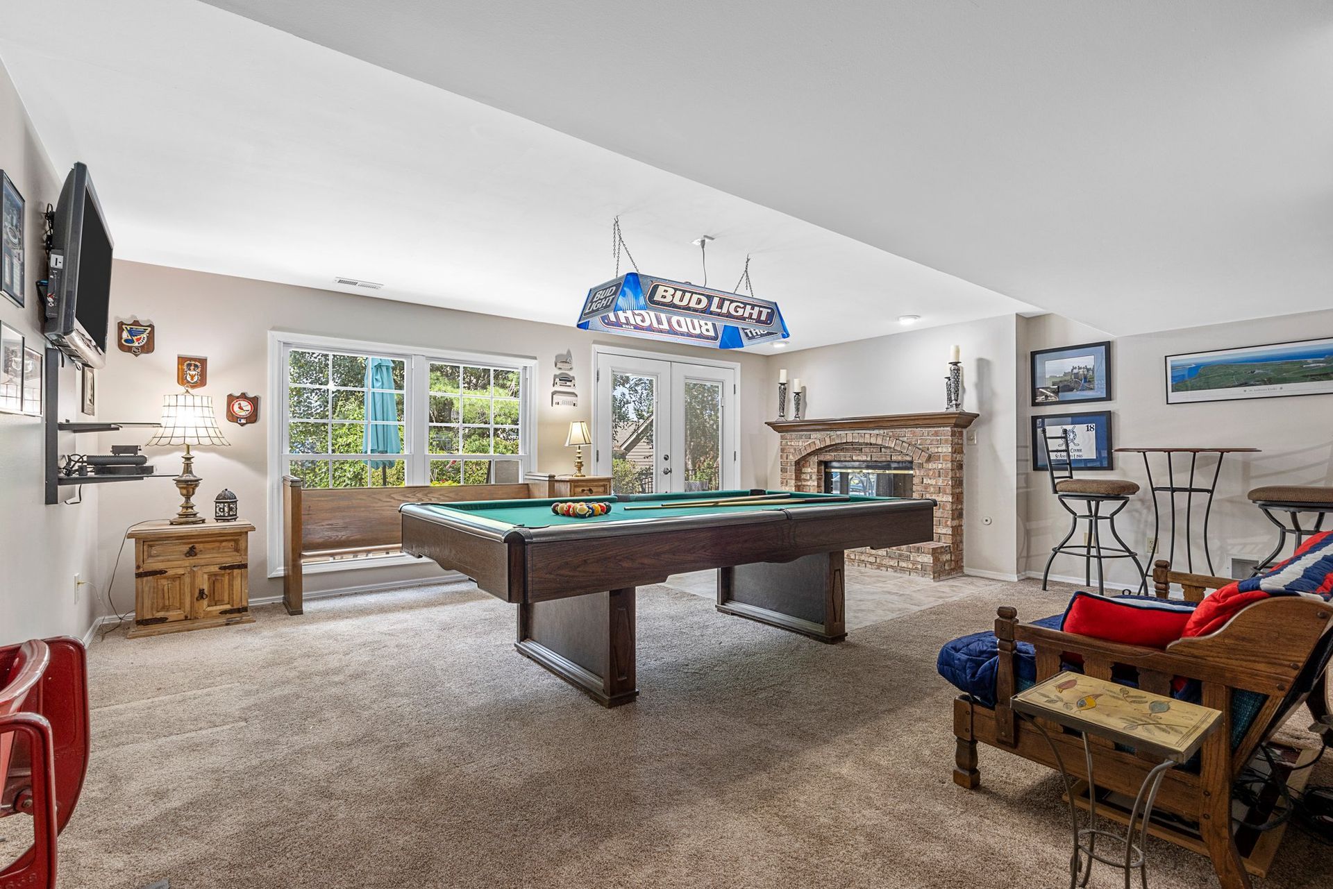 There is a pool table in the middle of the room.