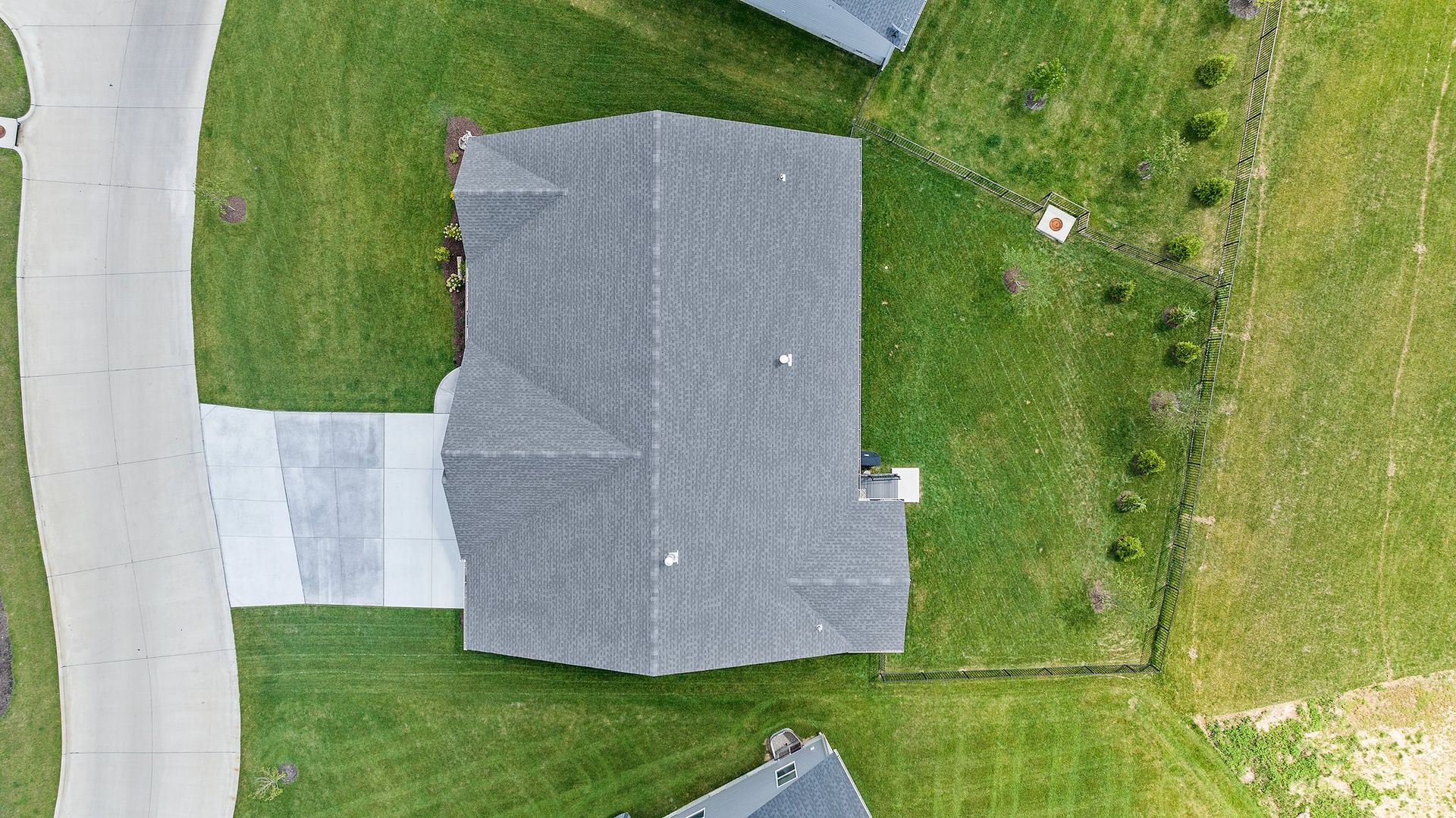 An aerial view of a house in a residential neighborhood.