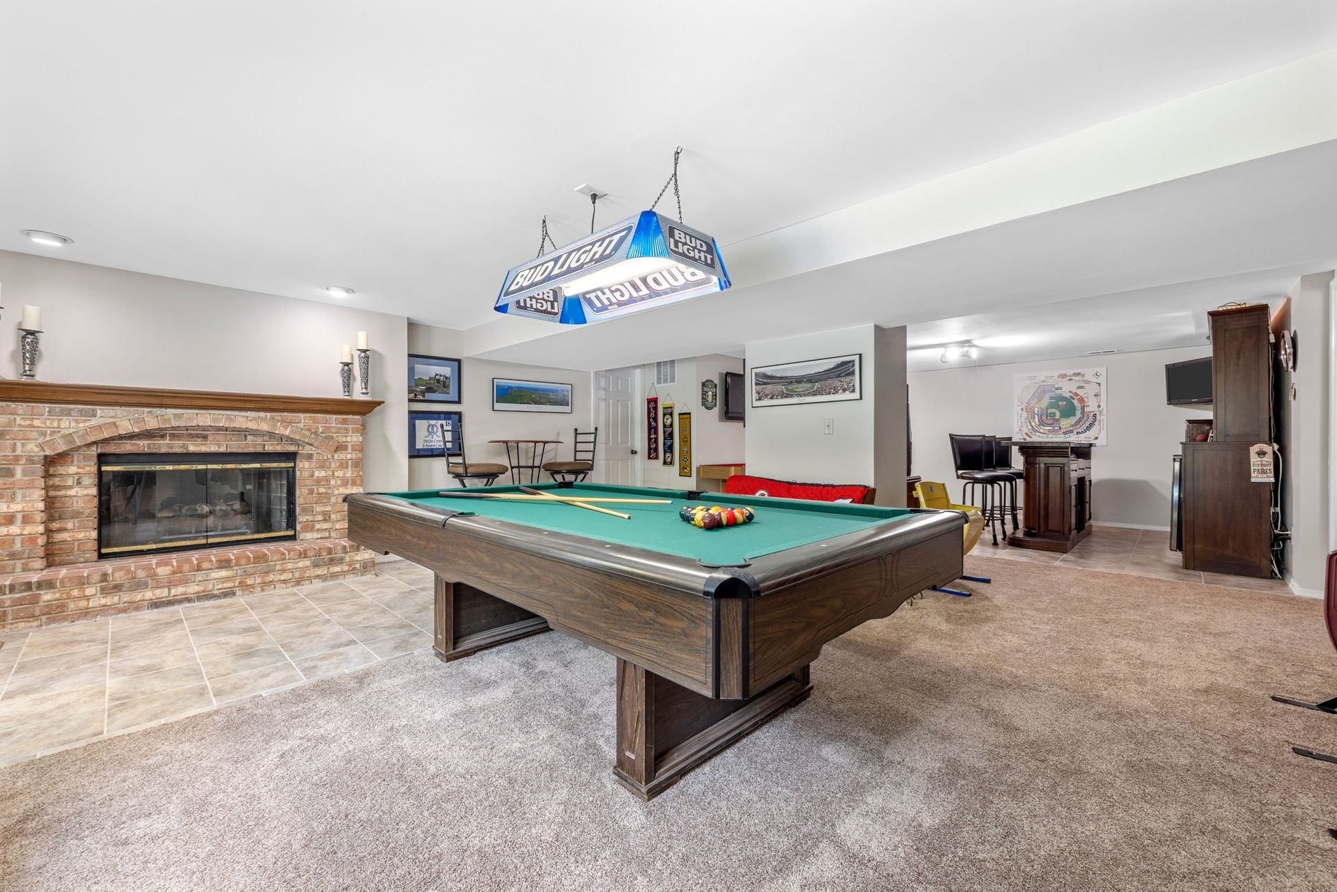 There is a pool table in the middle of the room.