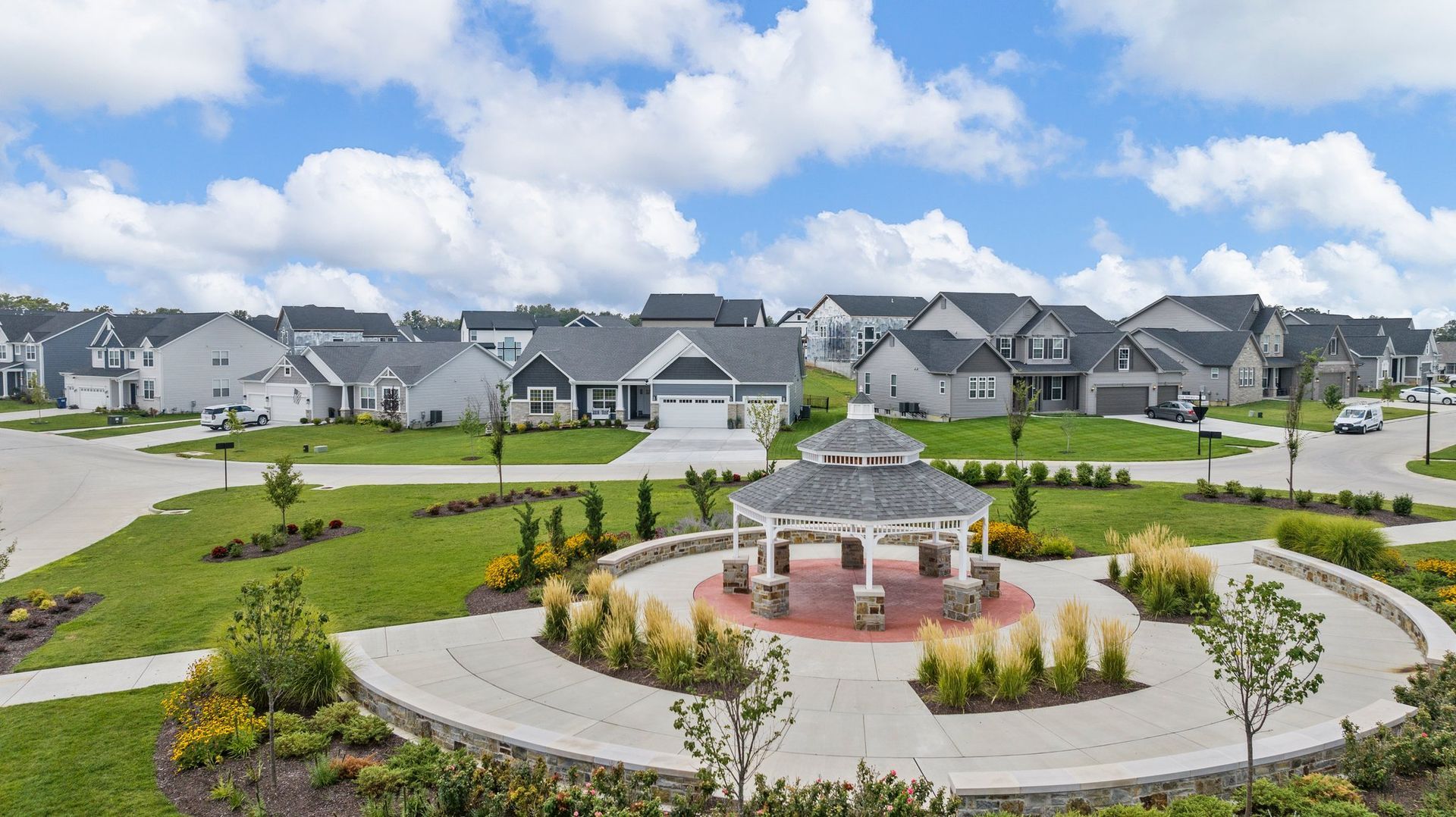 An aerial view of a residential neighborhood with a gazebo in the middle