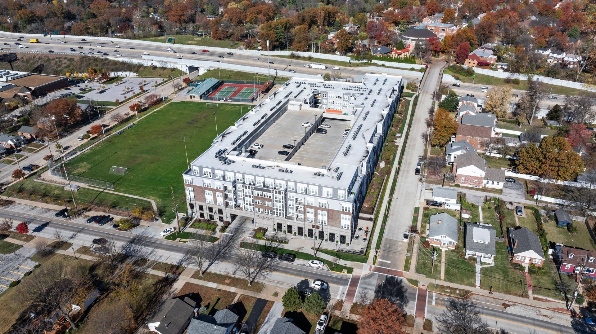 An aerial view of a large building in the middle of a residential area.