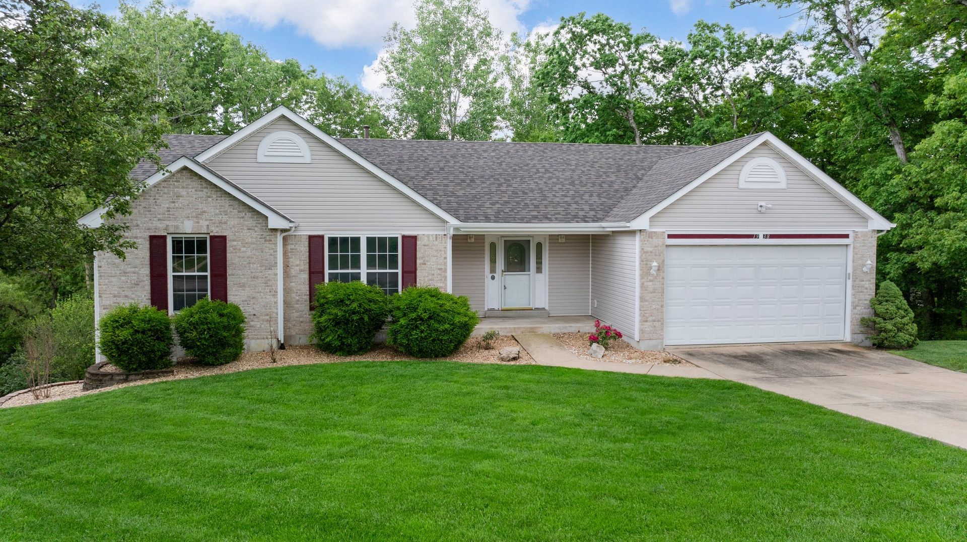 A house with a large lawn in front of it.