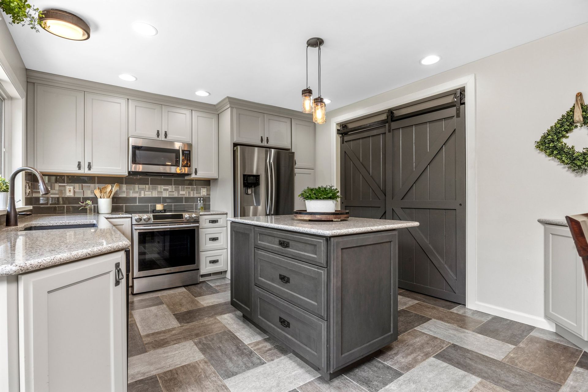 A kitchen with a large island and sliding barn doors.