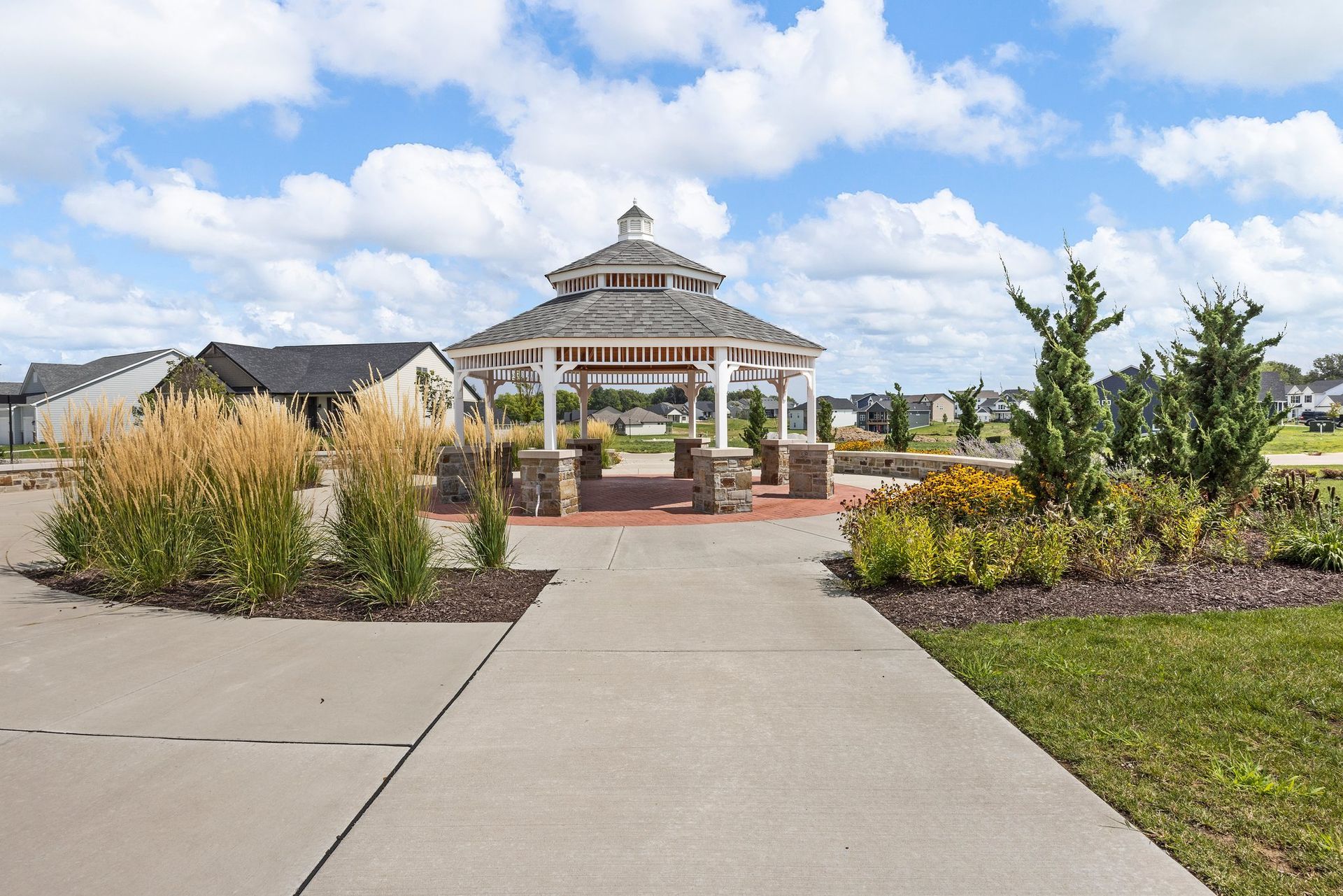 There is a gazebo in the middle of a park.