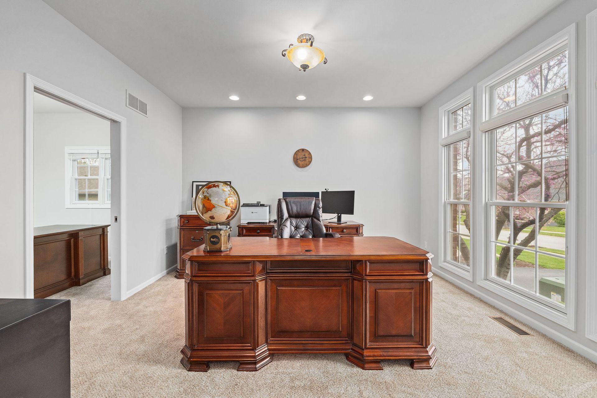 There is a large wooden desk in the middle of the room.