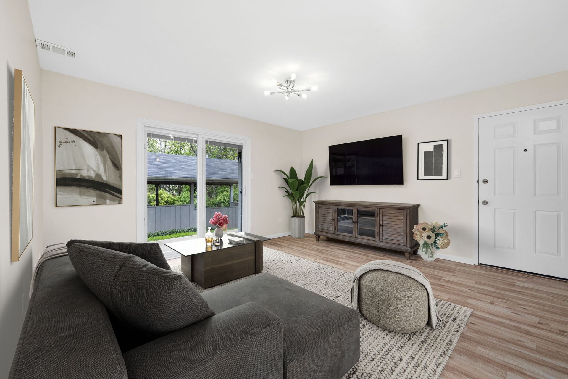 A living room with a couch and a flat screen tv.