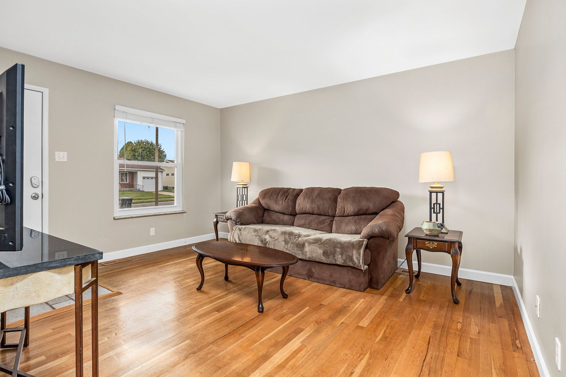 A living room with a couch , table , and television.