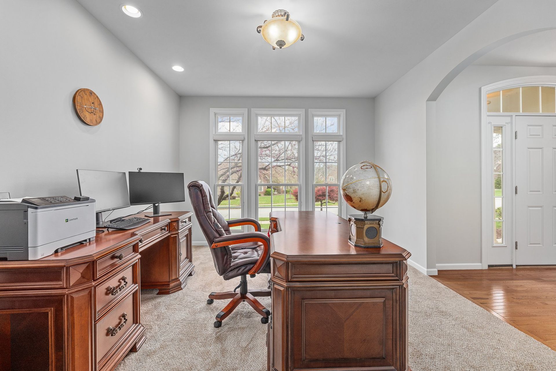 A home office with a desk , chair , computer and printer.