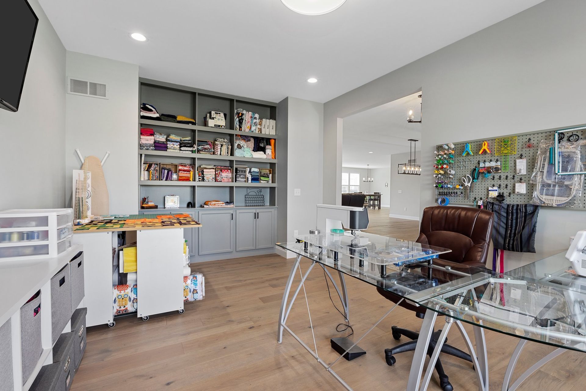 A home office with a glass desk and chair.