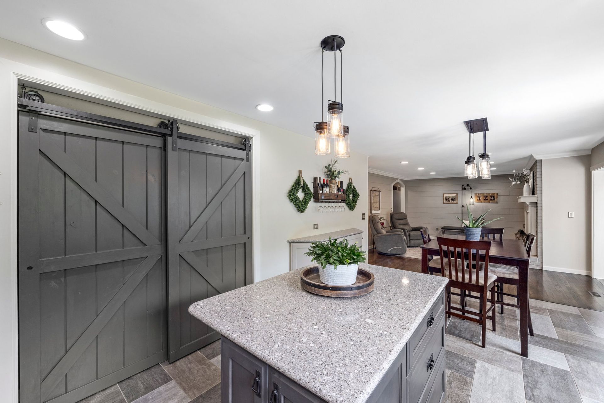 A kitchen with a large island and sliding barn doors.