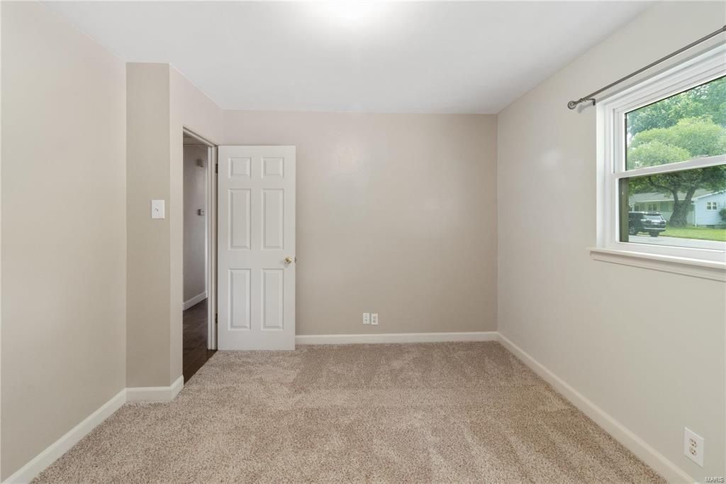 An empty room with a window and a door