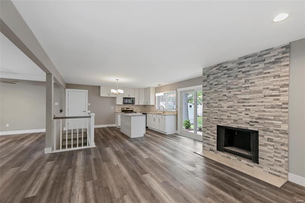 There is a fireplace in the middle of the living room.