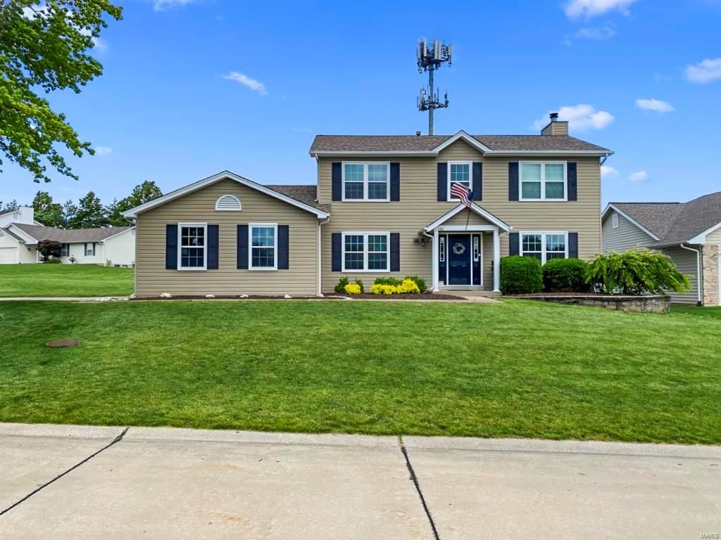 A large house with a lot of windows and black shutters