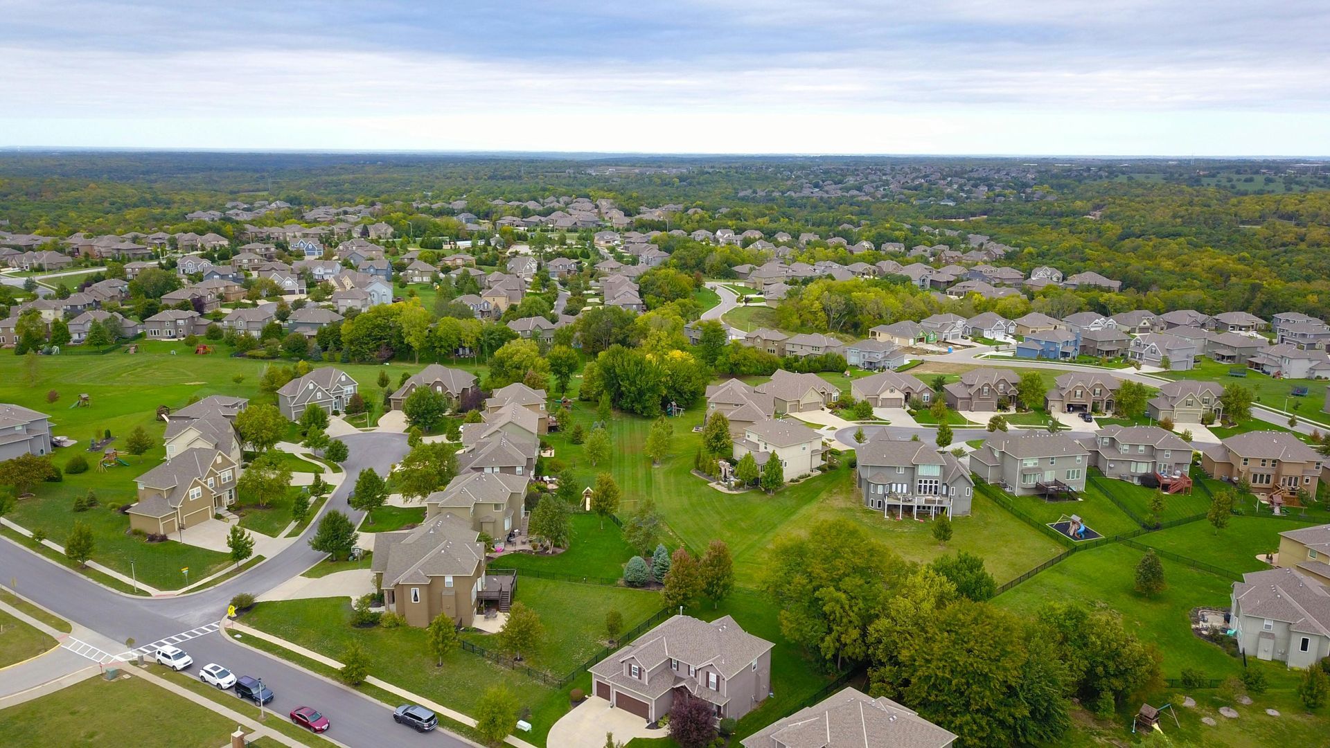 An aerial view of a residential area with lots of houses and trees.