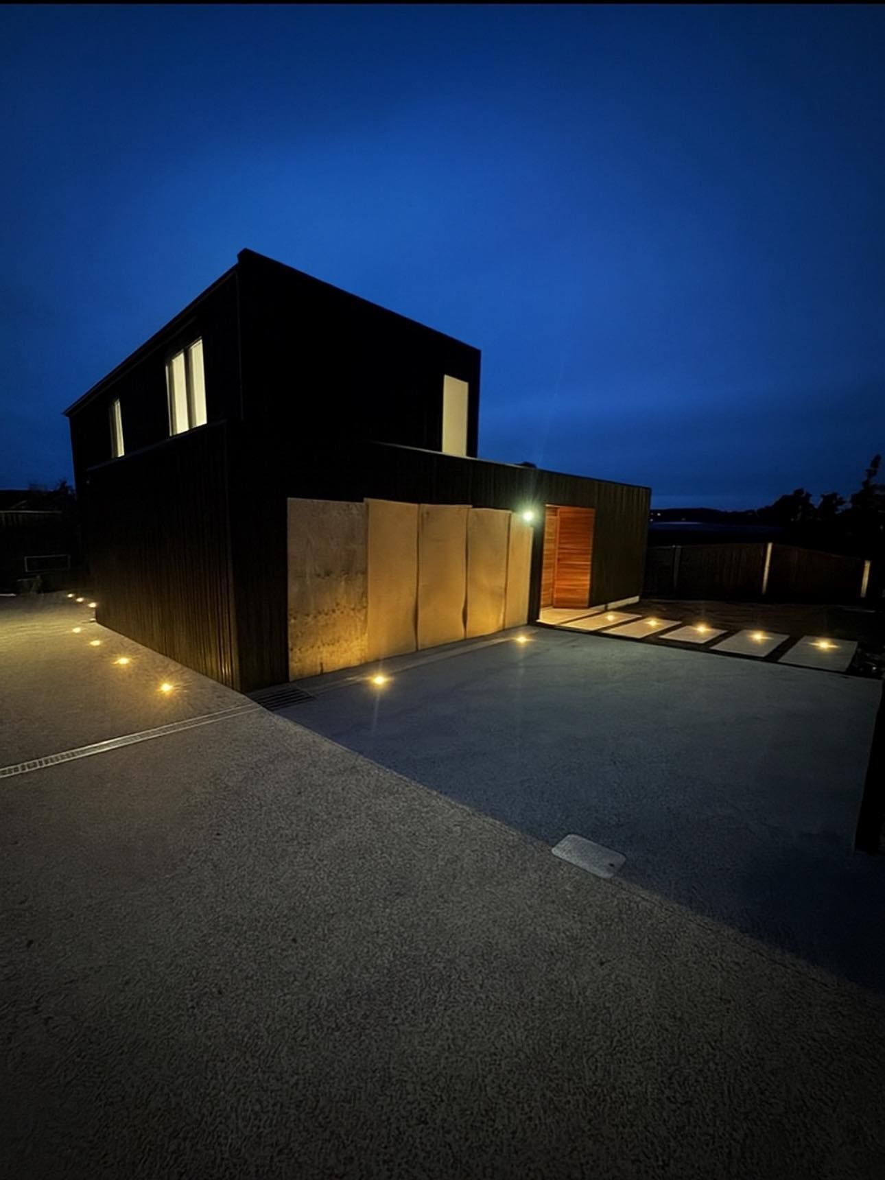 Wooden staircase with light under handrail.