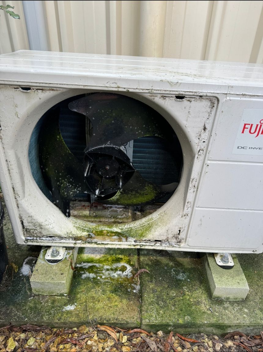 Exterior air conditioning unit with mold and algae.