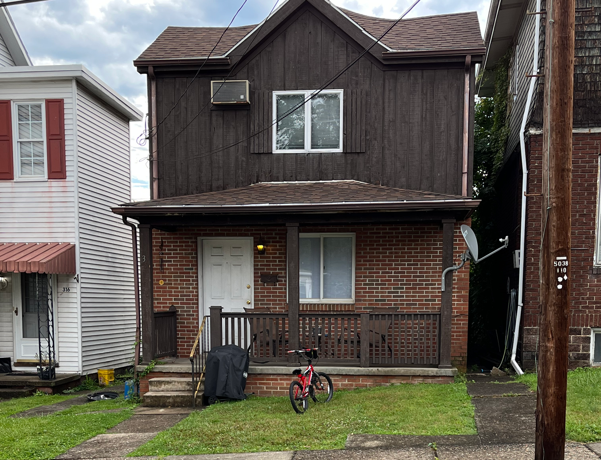 A brick house with a bicycle parked in front of it