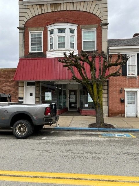 A house with a garage and a porch on a sunny day.