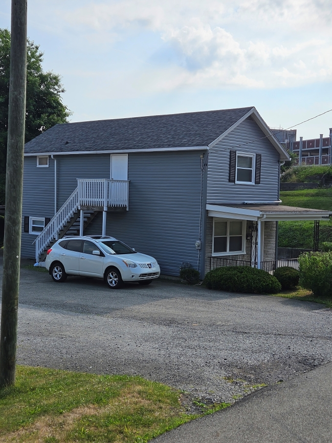 The front of a house with a porch and stairs