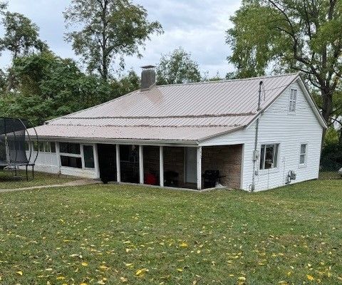 A person is holding a small model house in their hand.