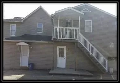 A large house with stairs leading up to the second floor