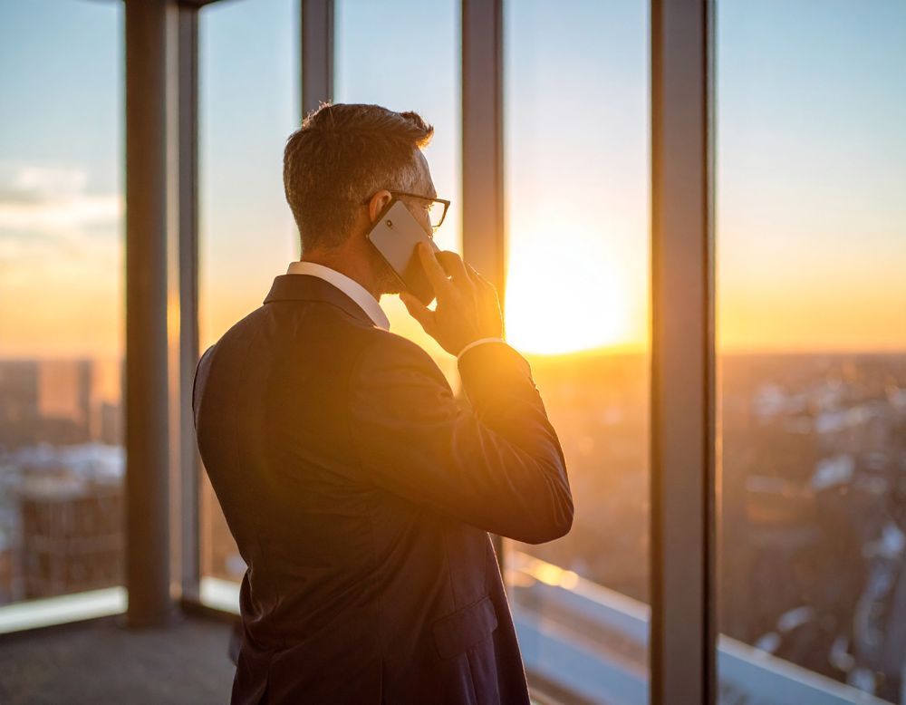 A business man calling an accountant through his phone in Columbia, TN