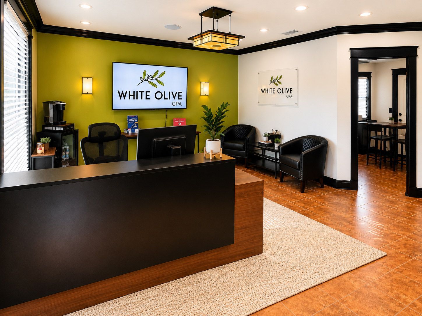 Modern dental office reception area with black desk, green accent wall, and seating area