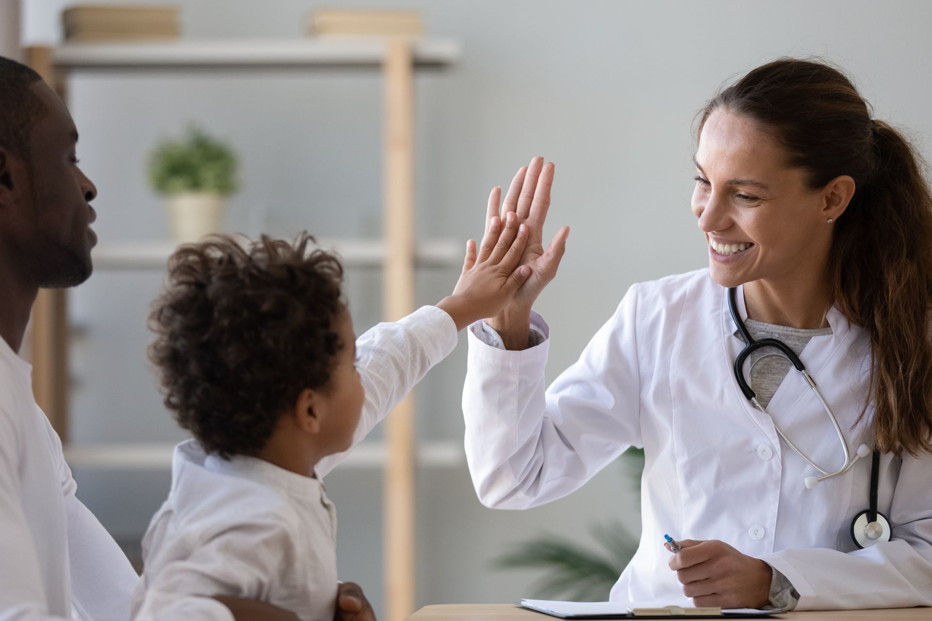 Doctor giving pediatric patient a high-five