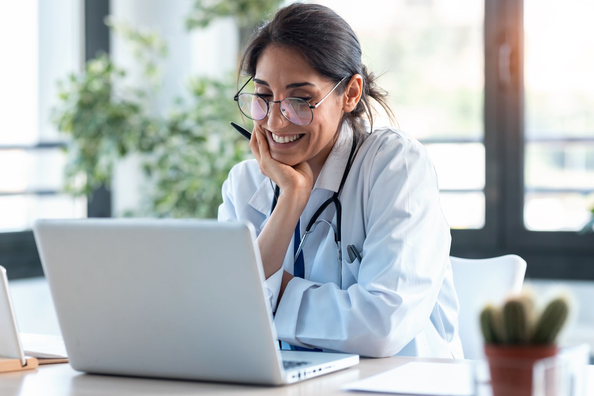 Physician looking at her medical website on a laptop