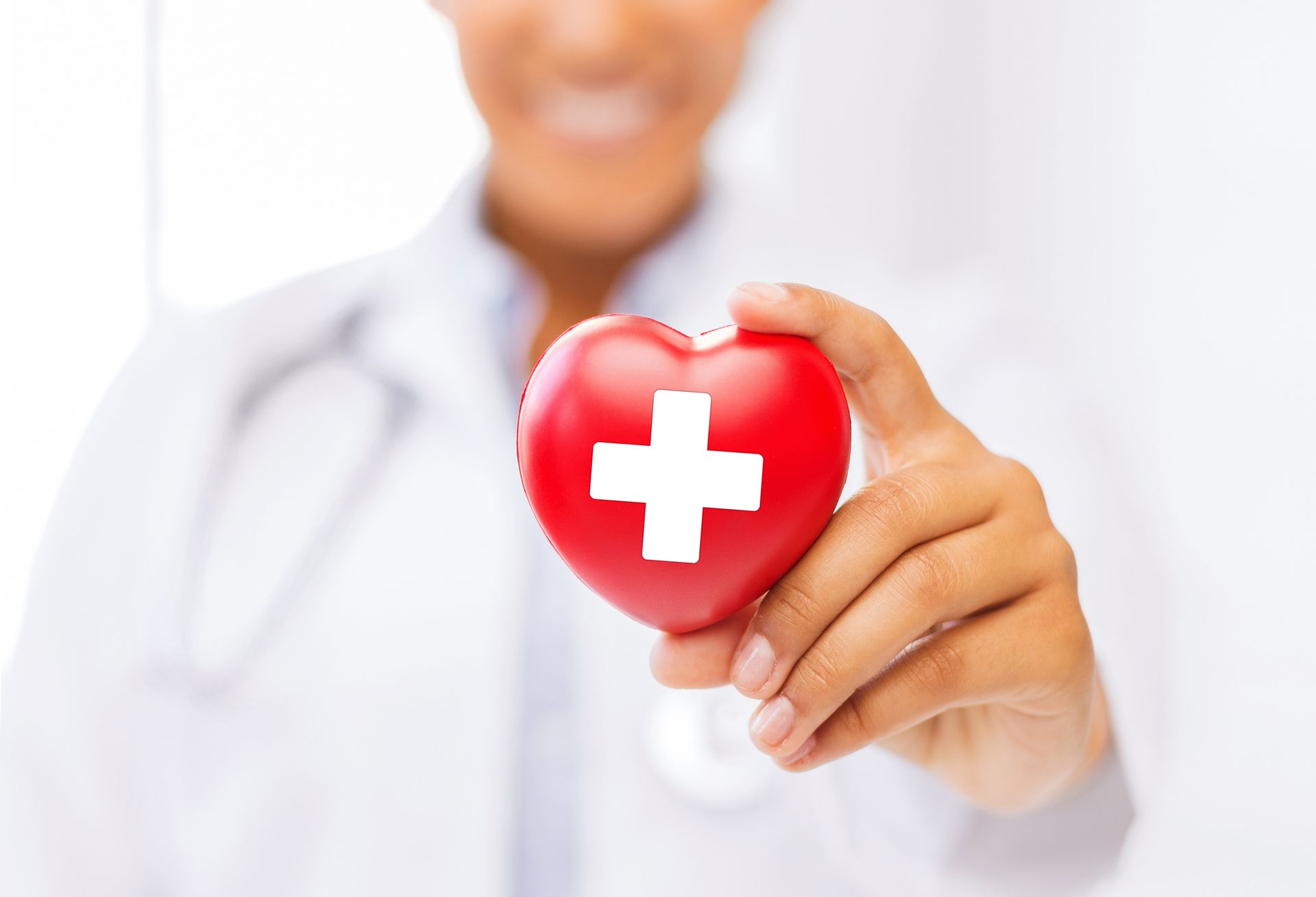 doctor holding a red cross symbol