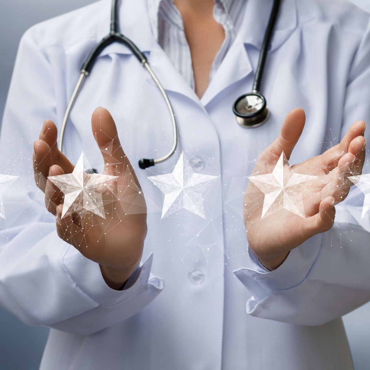 A doctor with a stethoscope around her neck is holding stars in her hands