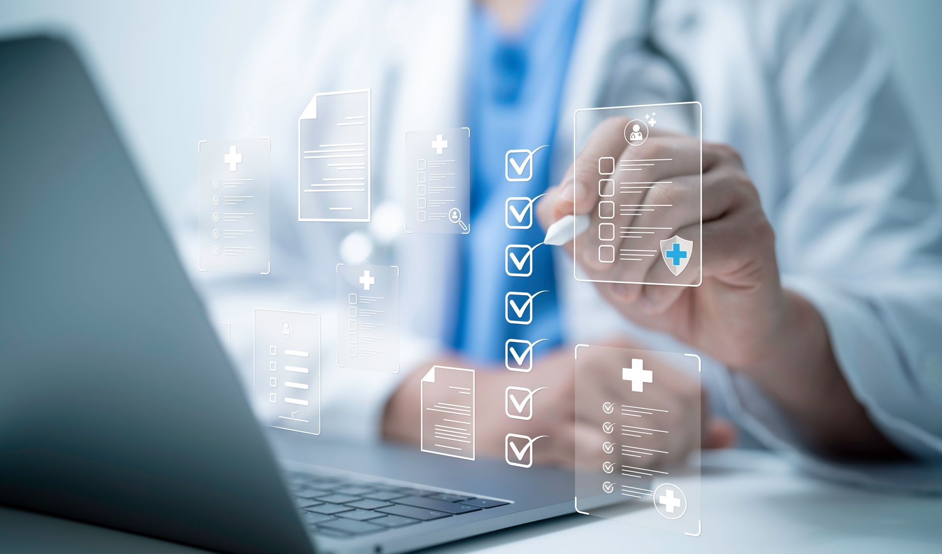 A doctor is using a laptop computer while holding a marker.